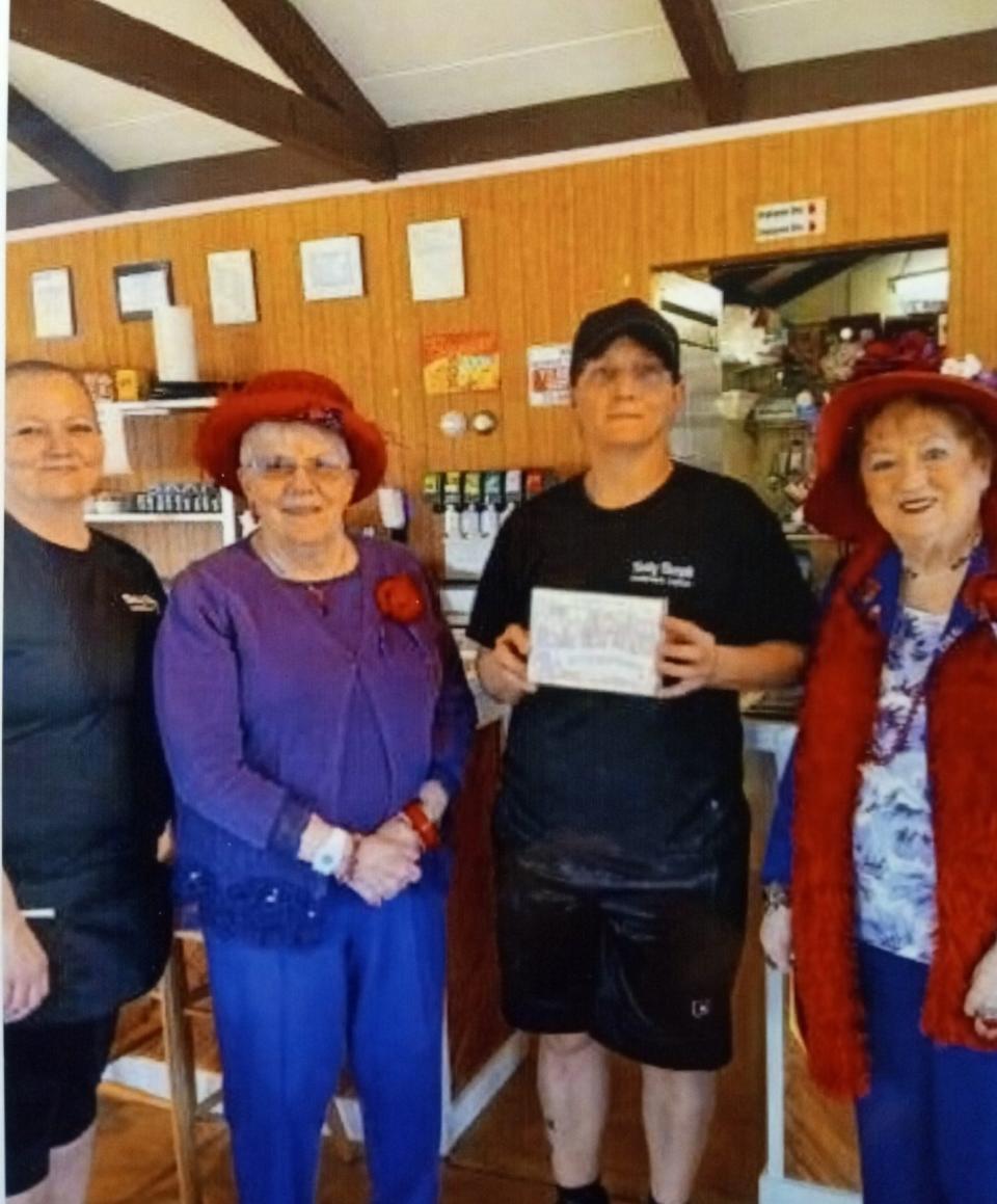 In April, the Bette Boop Babes Chapter of the Red Hat Society presented a picture of their group to Amy Scott, the new owner of the former Cherry Ridge Airport Restaurant outside Honesdale, since March 1 being known as the Betty Boops Airport Cafe. From left are Michelle Scott, sister of the owner, Vice Queen Judy Maneval, cafe owner Amy Scott and Queen Mother Dee Cullen.