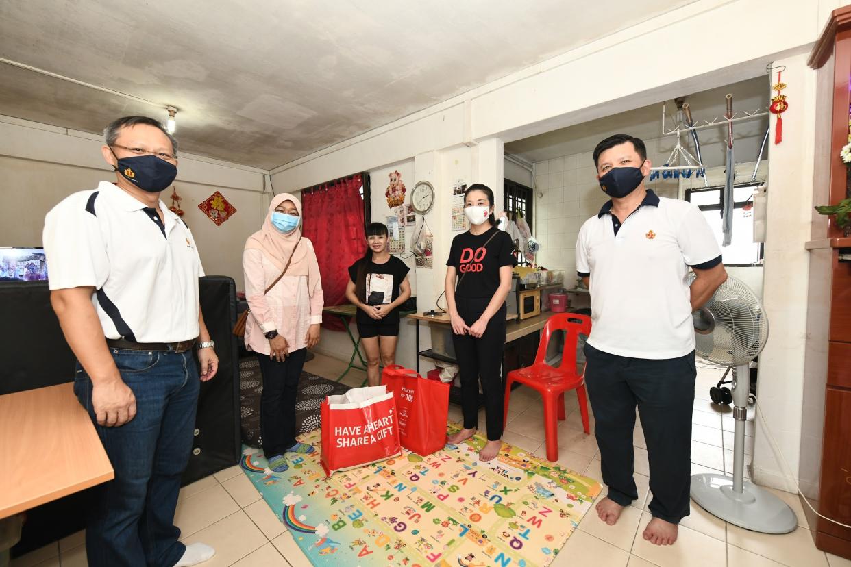 Guests from Boys’ Brigade, Prudential Singapore and Early Childhood Development Agency with KidSTART families in Jalan Kukoh at Boys’ Brigade Share-A-Gift 2020 first distribution drive. (PHOTO: Early Childhood Development Agency)