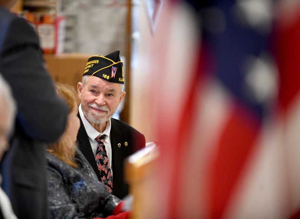 2022 Veteran of the Year Gary Ickes smiles as Larry Glasgow, past commander of Ohio's 10th District of the American Legion, presents his award at the Greater Canton Veterans Service Council's Veterans Day ceremony atAmerican Legion Post 44 in Canton.