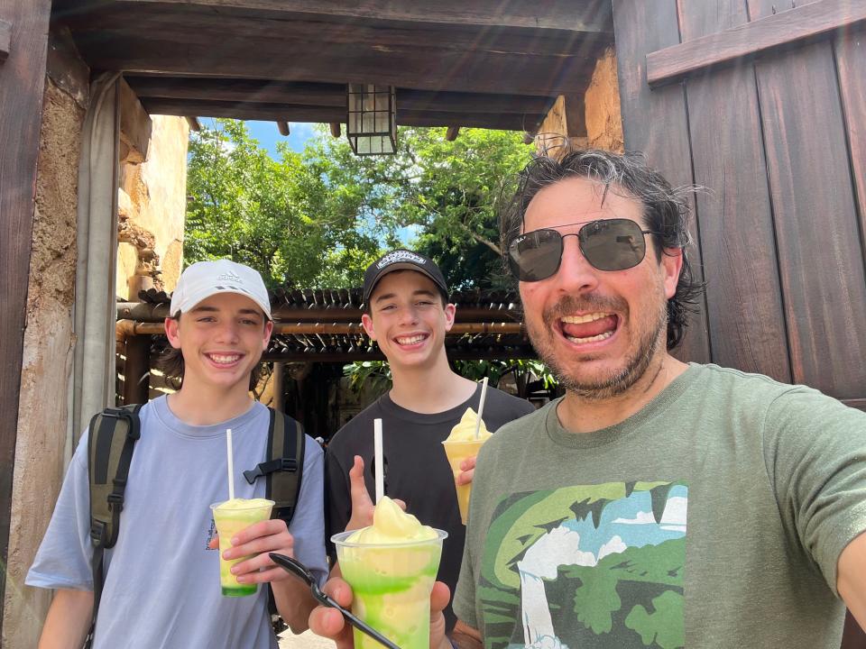 Ash Jurberg and his sons eating Dole Whip at Disney World.