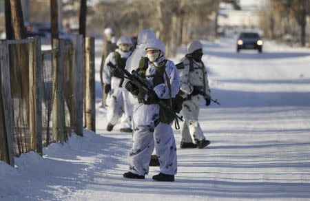 Law enforcement officers stand guard near a local school, after a student with an axe attacked schoolchildren and a teacher in the city of Ulan-Ude, Russia January 19, 2018. REUTERS/Anna Ogorodnik/BMK