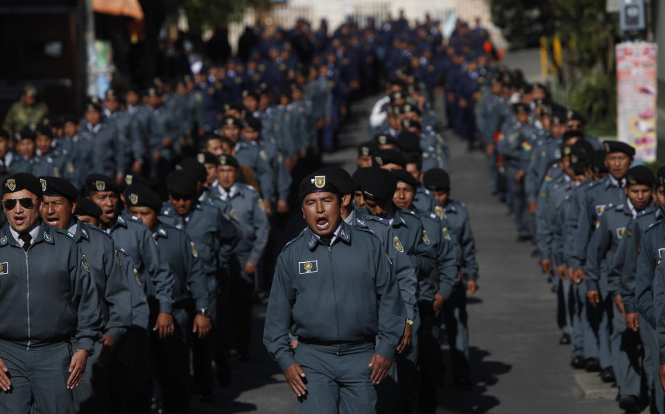 Army soldiers shout slogans as they protest in La Paz, Bolivia, Tuesday, April 22, 2014. Hundreds of low ranking soldiers from Bolivia's Armed Forces marched against the military high command's dismissal of four of its leaders who defended their call for more career opportunities. Soldiers who study three years to be sergeants and then warrant officers want to be given the opportunity to rise in rank, according to Felix Jhonny Gil, president of the National Association of Warrant Officers and Sergeants. The soldiers' wives started a hunger strike in solidarity. (AP Photo/Juan Karita)