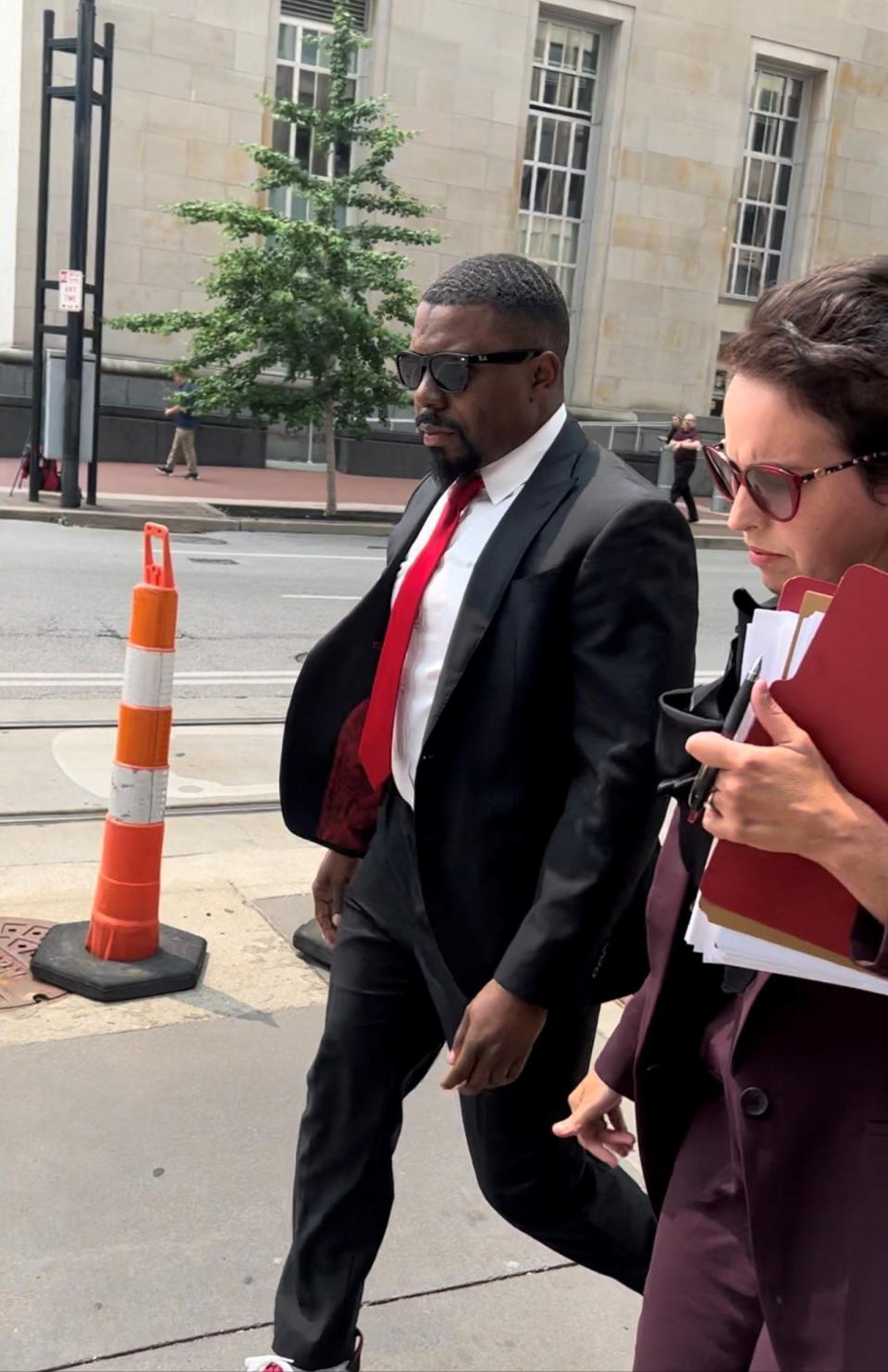 Jeff Pastor and his federal public defender, Karen Savir, walk outside the federal courthouse Downtown after Pastor pleaded guilty to honest services wire fraud on Wednesday.