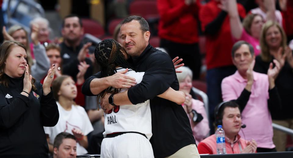 U of L head coach Jeff Walz embraced Chelsie Hall (23) after subbing her out of the game on senior day against Virginia Tech at the Yum Center in Louisville, Ky. on Feb. 20, 2022.  