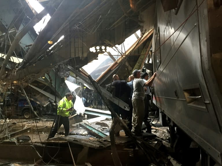 Train personel survey the NJ Transit train that crashed in to the platform at the Hoboken Terminal on September 29, 2016