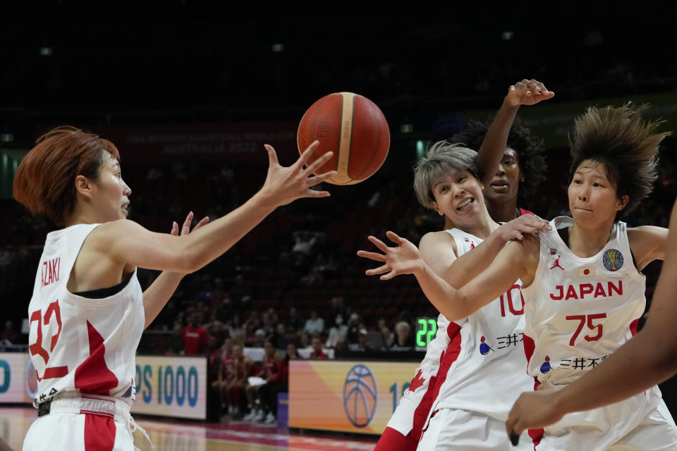 Japan's Saori Miyazaki, left, attempts to regather the ball during their game at the women's Basketball World Cup against Canada in Sydney, Australia, Sunday, Sept. 25, 2022. (AP Photo/Mark Baker)