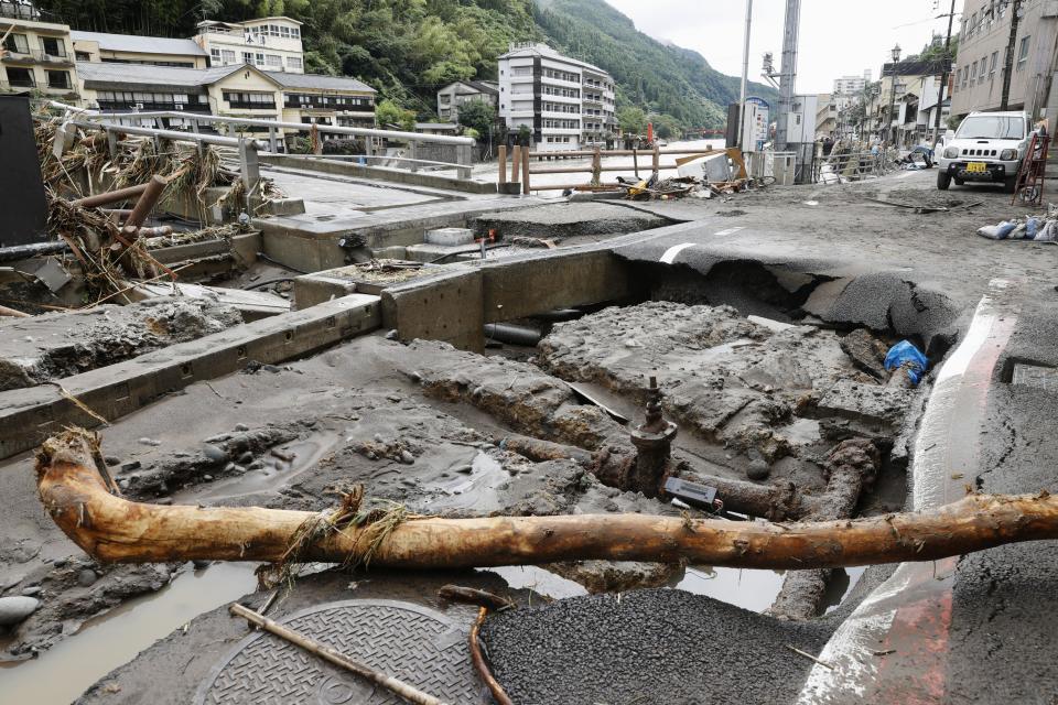A damaged road is seen following heavy rain in Hita, Oita prefecture, southern Japan Wednesday, July 8, 2020. Floodwaters flowed down streets in southern Japanese towns hit by heavy rains. (Miyuki Saito/Kyodo News via AP)