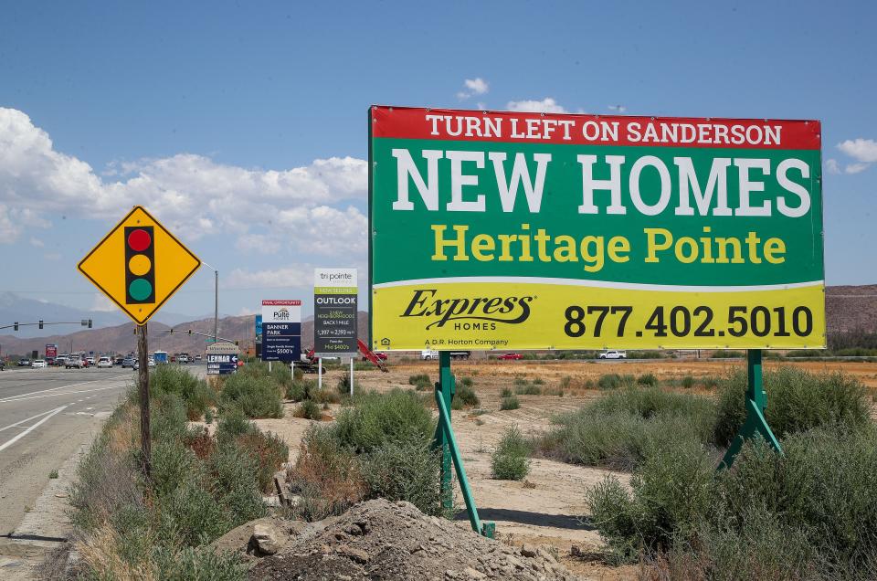 Signs advertising new homes can be seen along Domenigoni Parkway in Winchester, Calif., Aug. 14, 2023.