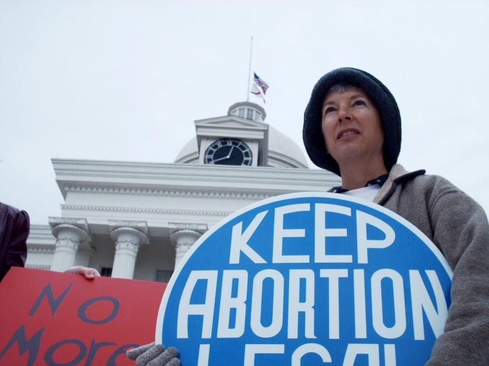 Amy Applegate holds a sign during a rally by the Montgomery chapter of the National Organization for Women as they gather on the steps of the State Capitol in Montgomery, Ala., Monday, Jan. 22, 2007, to celebrate the Roe v. Wade decision in 1973 that legalized abortion. (AP Photo/Desiree Hunter)