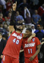 Dayton's Devon Scott (40) and Scoochie Smith (11) celebrate after the second half in a regional semifinal game against Stanford at the NCAA college basketball tournament, Thursday, March 27, 2014, in Memphis, Tenn. Dayton won 82-72. (AP Photo/John Bazemore)