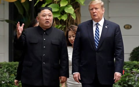 US President Donald Trump and North Korean leader Kim Jong-un take a walk after their first meeting at the Sofitel Legend Metropole Hanoi hotel in Hanoi - Credit: AP
