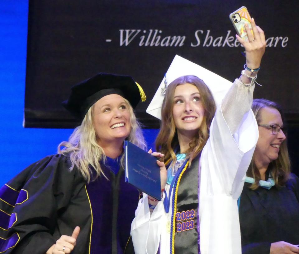 A senior takes a selfie with President/CEO Lisa Lamb of the Lewis Center for Educational Research during the Academy for Academic Excellence annual commencement ceremony on Friday, June 9, 2023 at High Desert Church in Victorville.