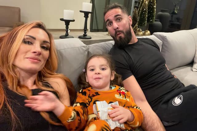 <p>Rebecca Quin/Instagram</p> Becky Lynch (left), her daughter Roux Lopez, and husband Seth Rollins