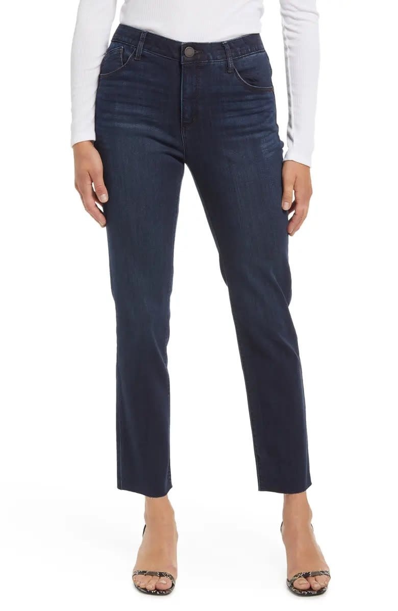 woman wears blue dark wash Wit & Widsom Ab'Solution Raw Hem Slim Straight Jeans. Image via Nordstrom.