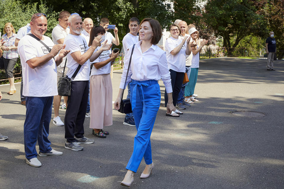 Moldova's President Maia Sandu arrives at a polling station to cast her vote in a snap parliamentary election, in Chisinau, Moldova, Sunday, July 11, 2021. Moldovan citizens vote in a key snap parliamentary election that could decide whether the former Soviet republic fully embraces pro-Western reform or prolongs a political impasse with strong Russian influence. (AP Photo/Aurel Obreja)