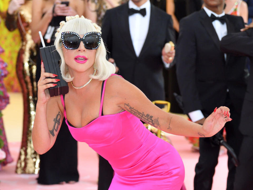 Lady Gaga on the red carpet with a huge phone to her ear