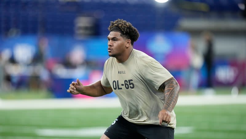 Brigham Young offensive lineman Kingsley Suamataia runs a drill at the NFL football scouting combine, Sunday, March 3, 2024, in Indianapolis.