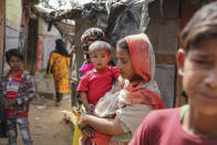 Rohingyas refugees stand at a makeshift camp on the outskirts of Jammu, India, Sunday, March 7, 2021. Authorities in Indian-controlled Kashmir have sent at least 168 Rohingya refugees to a holding center in a process which they say is to deport thousands of the refugees living in the region. (AP Photo/Channi Anand)