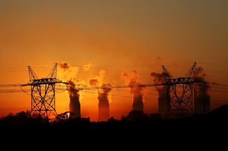 Electricity pylons are seen in front of the cooling towers at the Lethabo Thermal Power Station,an Eskom coal-burning power station near Sasolburg in the northern Free State province, March 2, 2016. REUTERS/Siphiwe Sibeko/File Photo