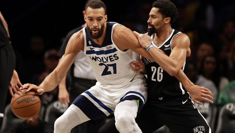 Minnesota Timberwolves center Rudy Gobert (27) drives to the basket against Brooklyn Nets guard Spencer Dinwiddie during the second half of an NBA basketball game, Tuesday, April 4, 2023, in New York. (AP Photo/Adam Hunger)