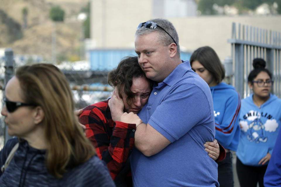 Students are escorted out of Saugus High School as some parents join them after reports of a shooting on Thursday, Nov. 14, 2019, in Santa Clarita, Calif. (AP Photo/Marcio Jose Sanchez)