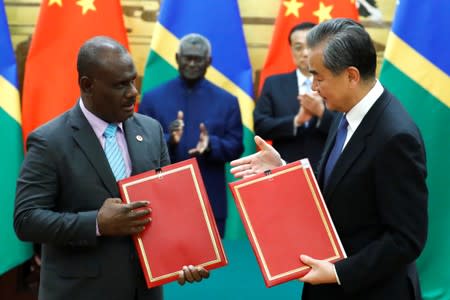 Chinese State Councillor and Foreign Minister Wang Yi and Solomon Islands Foreign Minister Jeremiah Manele attend a signing ceremony at the Great Hall of the People in Beijing