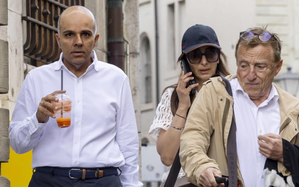 Ajay Hinduja (L) and his wife Namrata arrive with their lawyer Robert Assael at the court house for the resumption day of the trial against members of Indian billionaire family