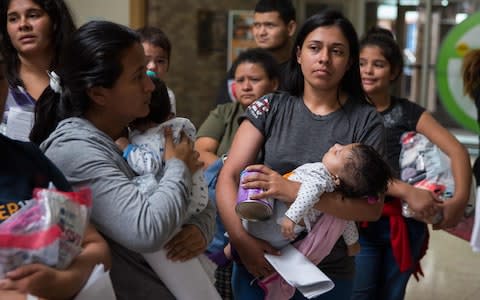 Migrants caught trying to enter the US illegally are being separated from their children - Credit: LOREN ELLIOTT/AFP