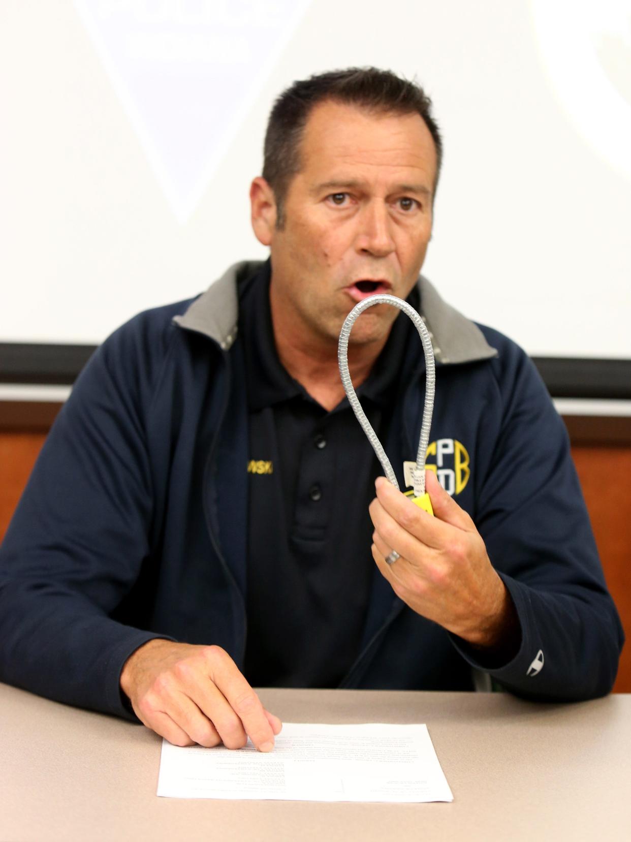 South Bend Police Chief Scott Ruszkowski speaks about gun locks Wednesday at a news conference involving the shooting death of 1-year-old Kylin Brooks. He is holding one of the locks the police department distributes free of charge to people who ask for them.