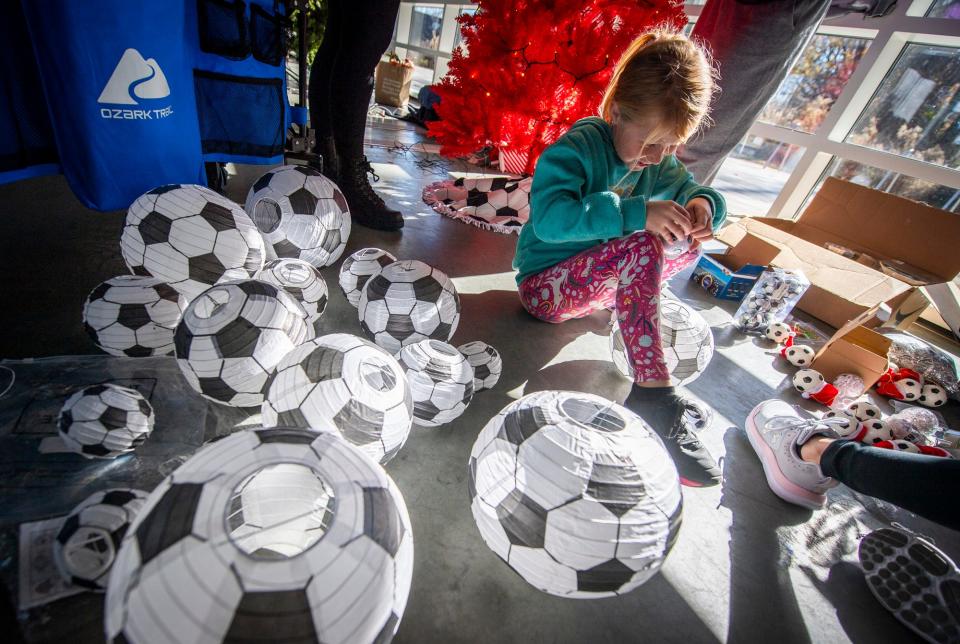 Ella Matulis puts hooks in soccer-themed ornaments for the Cutters Soccer Club's "Getting a Kick Out of the Holidays," an entry into for Hope for the Holidays, a charity sale and auction benefitting New Hope for Families.