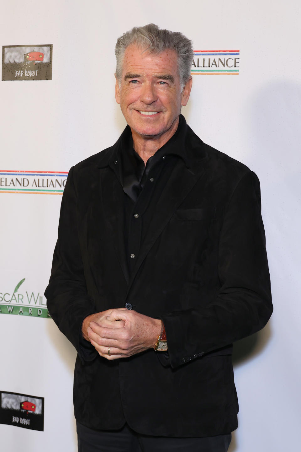 Pierce Brosnan in a black velvet blazer and shirt at an event