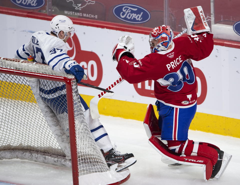 Laval Rocket goaltender Carey Price, right, collides with Toronto Marlies' Scott Pooley during first-period American Hockey League action in Montreal, Monday, May 17, 2021. Price and Brendan Gallagher are on a one-game conditioning loan to the Rocket before their playoff series against the Toronto Maple Leafs. (Ryan Remiorz/The Canadian Press via AP)