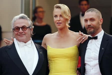(L-R) Director George Miller, cast members Charlize Theron and Tom Hardy pose on the red carpet as they arrive for the screening of the film "Mad Max: Fury Road" out of competition at the 68th Cannes Film Festival in Cannes, southern France, May 14, 2015. REUTERS/Regis Duvignau