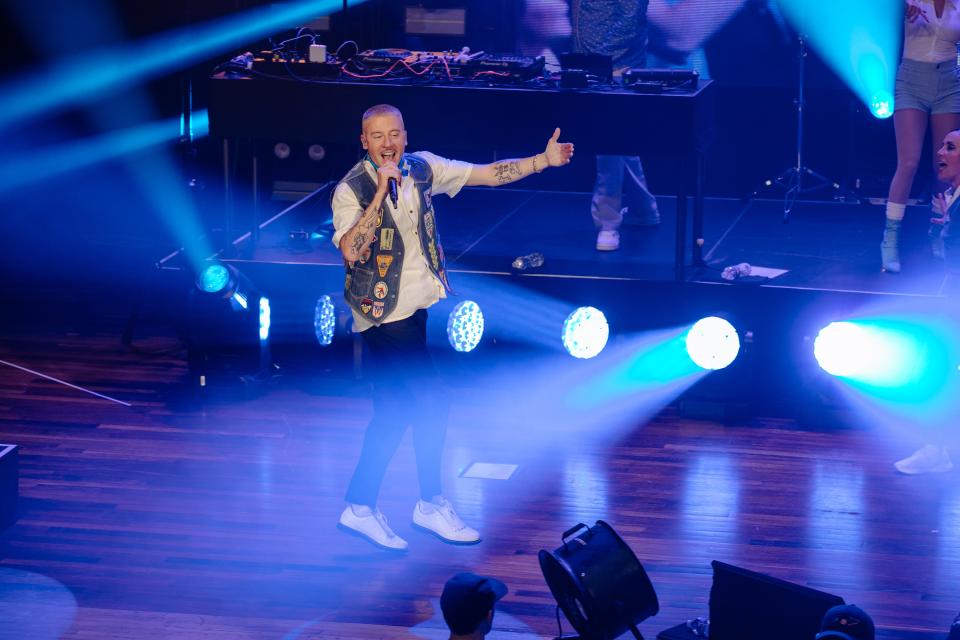 Macklemore rapping on the stage of the Ryman Auditorium on Sept. 17.