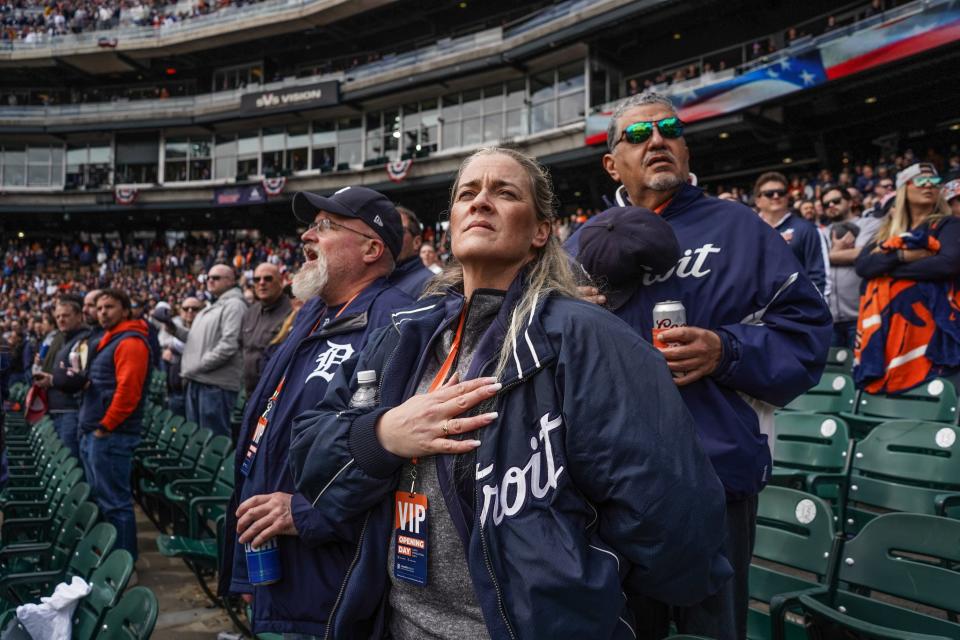 Diana Smith of Saline holds her hat to her chest as "God Bless America" is played during the Detroit Tigers Opening Day against the Boston Red Sox at Comerica Park in Detroit on Thursday, April 6, 2023.