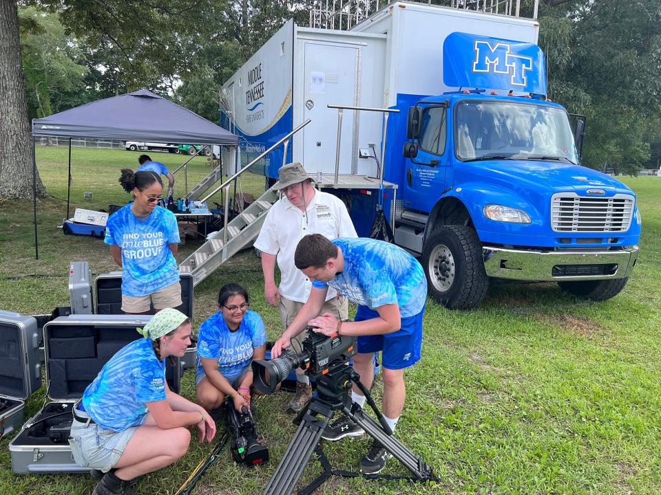 Robert Gordon, second from right, associate professor in MTSU’s Media Arts Department, helps students Wednesday, June 15, prepare to provide video and streaming services from the university’s Mobile Production Lab.