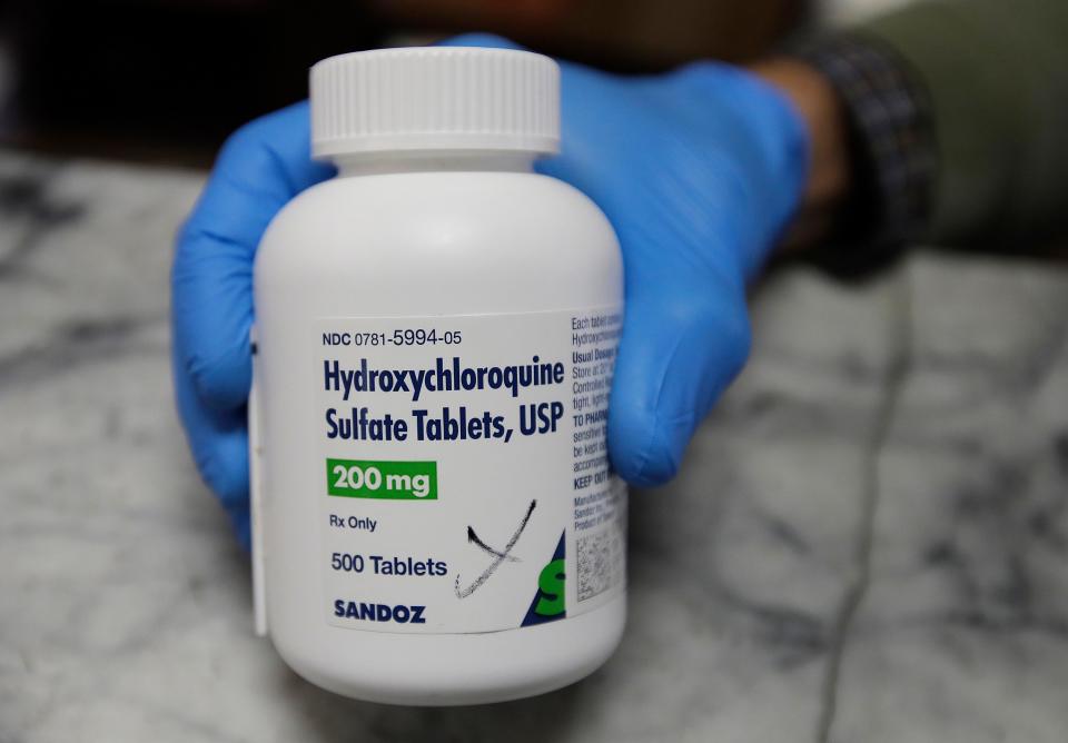 A pharmacist shows a bottle of the drug hydroxychloroquine on April 6, 2020, in Oakland, California. The malaria drug is not yet officially approved for fighting the new coronavirus, and scientists say more testing is needed before it's proven safe and effective against COVID-19.