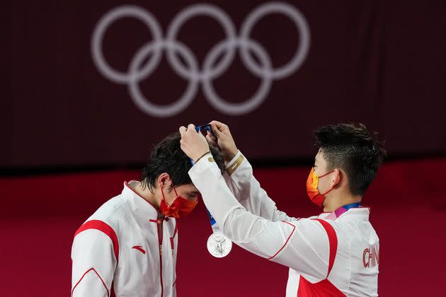 Silver medalists Li Junhui and Liu Yuchen of Team China are seen during the medal ceremony for the men's doubles badminton event on July 31. (Photo: VCG via Getty Images)