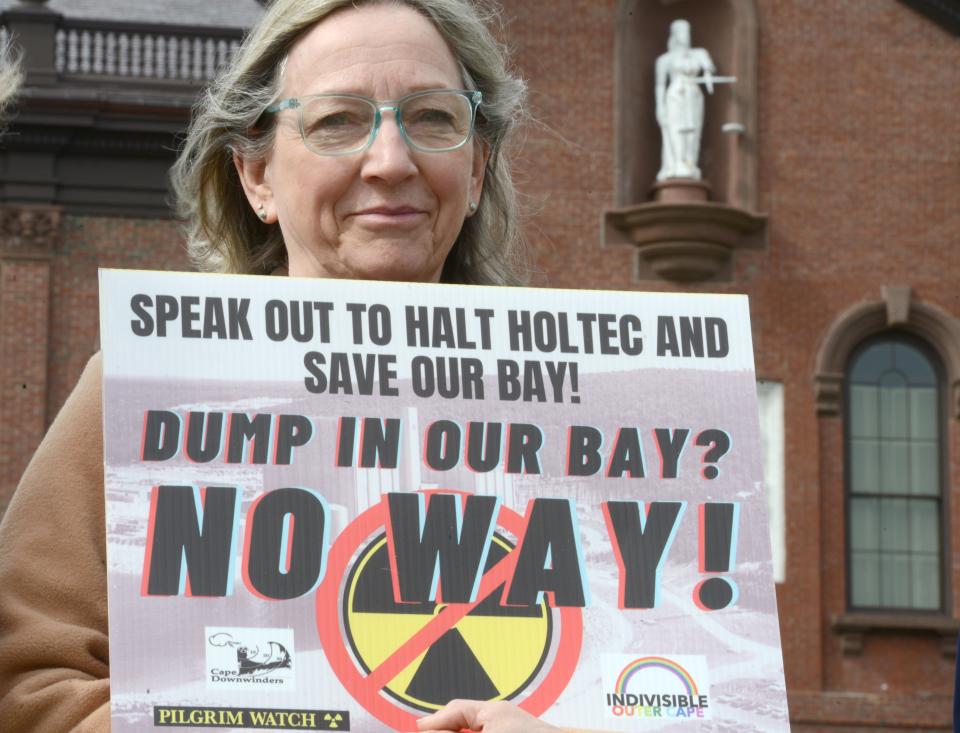 The Lady of Justice looks down as Harwich's Diane Turco joins a group of demonstrators outside Plymouth Town Hall on Friday morning where U.S. Sen. Ed Markey conducted a field hearing on issues facing communities with decommissioning nuclear plants. Steve Heaslip/Cape Cod Times