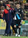 Arsenal's French defender Laurent Koscielny (R) leaves the pitch injured during the English Premier League football match between Norwich City and Arsenal at Carrow Road in Norwich, eastern England on November 29, 2015