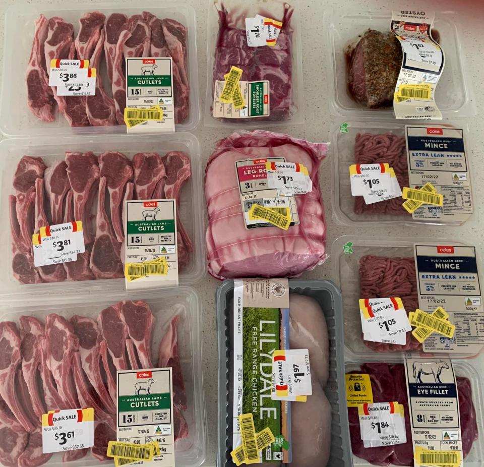 Discounted Coles meat products laid out on table.