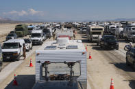 Vehicles line up to leave the Burning Man festival in Black Rock Desert, Nev., Tuesday, Sept. 5, 2023. The traffic jam leaving the festival eased up considerably Tuesday as the exodus from the mud-caked Nevada desert entered a second day following massive rain that left tens of thousands of partygoers stranded there for days. (Monique Sady via AP)
