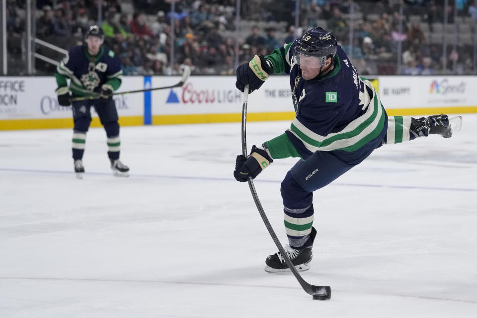 Vancouver Canucks center J.T. Miller shoots against the San Jose Sharks during the second period of an NHL hockey game in San Jose, Calif., Wednesday, Dec. 7, 2022. (AP Photo/Godofredo A. Vásquez)