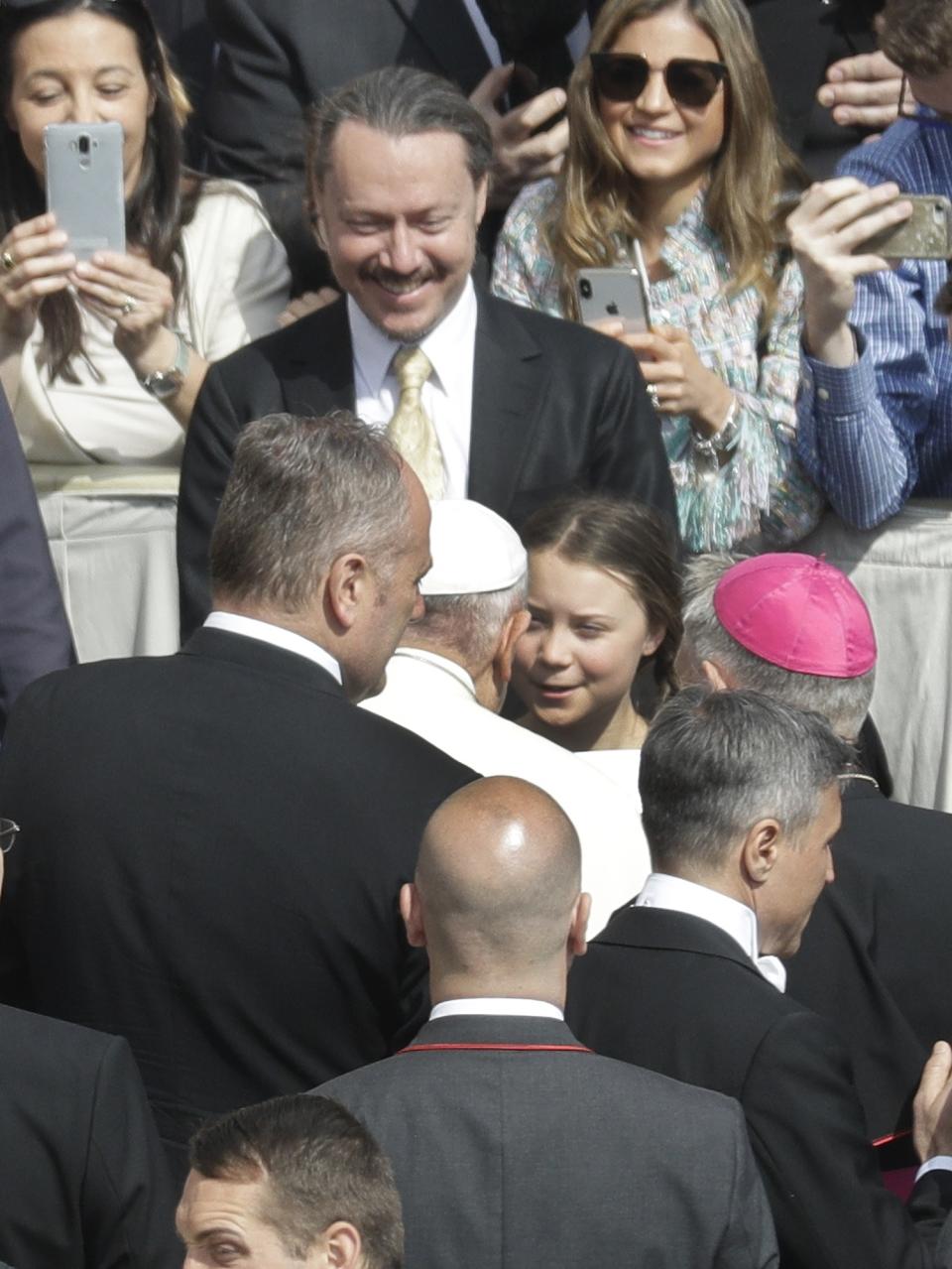 Pope Francis greets Swedish teenage environmental activist Greta Thunberg during his weekly general audience in St. Peter's Square, at the Vatican, Wednesday, April 17, 2019. (AP Photo/Gregorio Borgia)