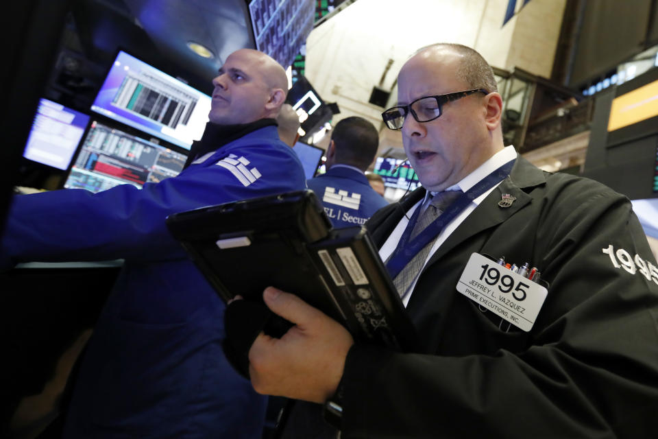 Specialist Mark Fitzgerald, left, and trader Jeffrey Vazquez work on the floor of the New York Stock Exchange, Wednesday, Jan. 9, 2019. Stocks are opening higher on Wall Street, putting the market on track for a fourth gain in a row. (AP Photo/Richard Drew)