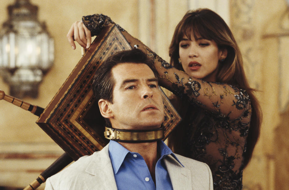 Irish actor Pierce Brosnan stars as 007 opposite French actress Sophie Marceau as Elektra King in the James Bond film 'The World Is Not Enough' 1999. In the scene, Elektra uses an antique device to torture the imprisoned Bond. (Photo by Keith Hamshere/Getty Images)