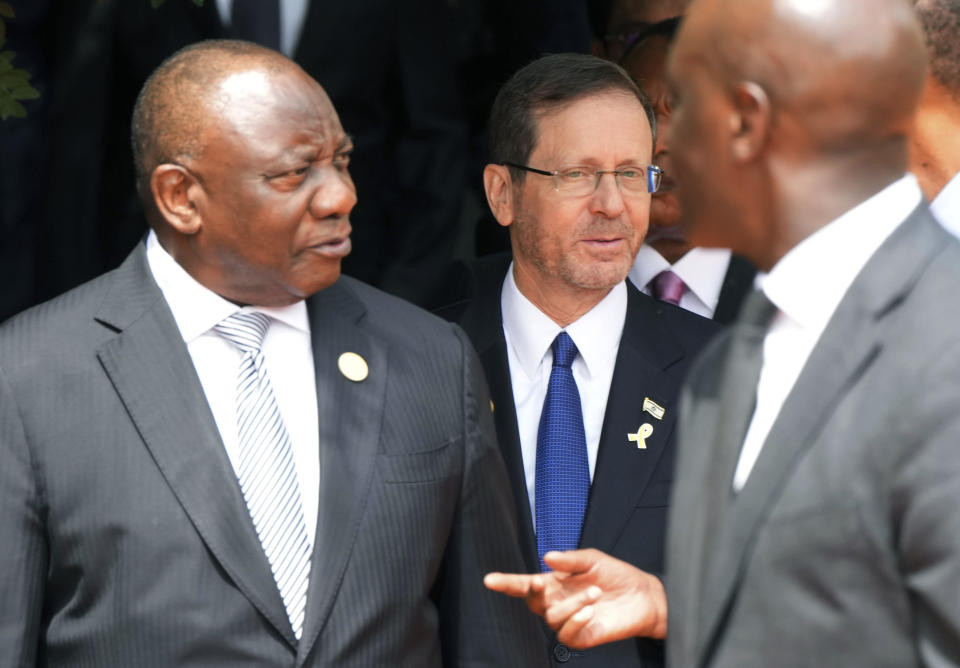Israel President Isaac Herzog, centre, walks behind South Africa's President Cyril Ramaphosa, to lay a wreath at the Kigali Genocide Memorial, in Kigali, Rwanda Sunday, April 7, 2024. Rwanda is commemorating the 30th anniversary of when the country descended into an orgy of violence in which some 800,000 Tutsis and moderate Hutus were massacred by the majority Hutu population over a 100-day period in what was the worst genocide in recent history. (AP Photo/Brian Inganga)