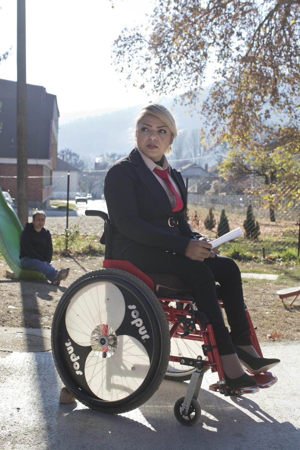 In this photo taken Tuesday, Nov. 13, 2018, Mahana Jami, 34, inside a government run camp for refugees and migrants in Bosilegrad, some 250 kilometers southeast of Belgrade, Serbia. As a little girl in a wheelchair in Iran, Jami used to watch other children play on a slide and wondered why she couldn't do the same. She then made a promise to herself to always dream big and never let her disability stand in the way. (AP Photo/Marko Drobnjakovic)