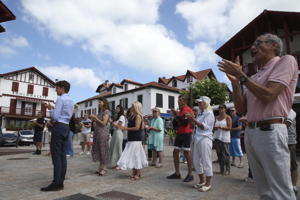 Residents applaud a speech during a gathering in a show of solidarity with the mayor of the Paris suburb of L'Hay-les-Roses after a burning car struck his home, Monday July 3, 2023 in Bidart, southwestern France. Unrest across France sparked by the police shooting of a 17-year-old appeared to slow on its sixth night, but still public buildings, cars and municipal trash cans were targeted nationwide by fires and vandalism overnight into Monday. (AP Photo/Bob Edme)