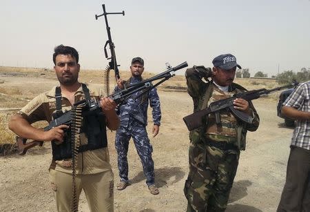 Members of Iraqi security forces and tribal fighters take part in an intensive security deployment on the outskirts of Diyala province June 13, 2014. REUTERS/Stringer